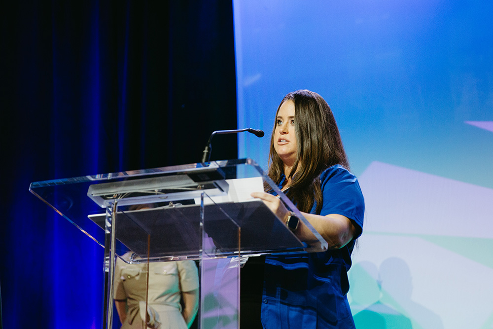 Ashley Bellew speaking to the attendees of the Healthcare Governance Conference after being presented the 2024 Ollie Jo Bozeman Excellence in Administrative Professionalism Award